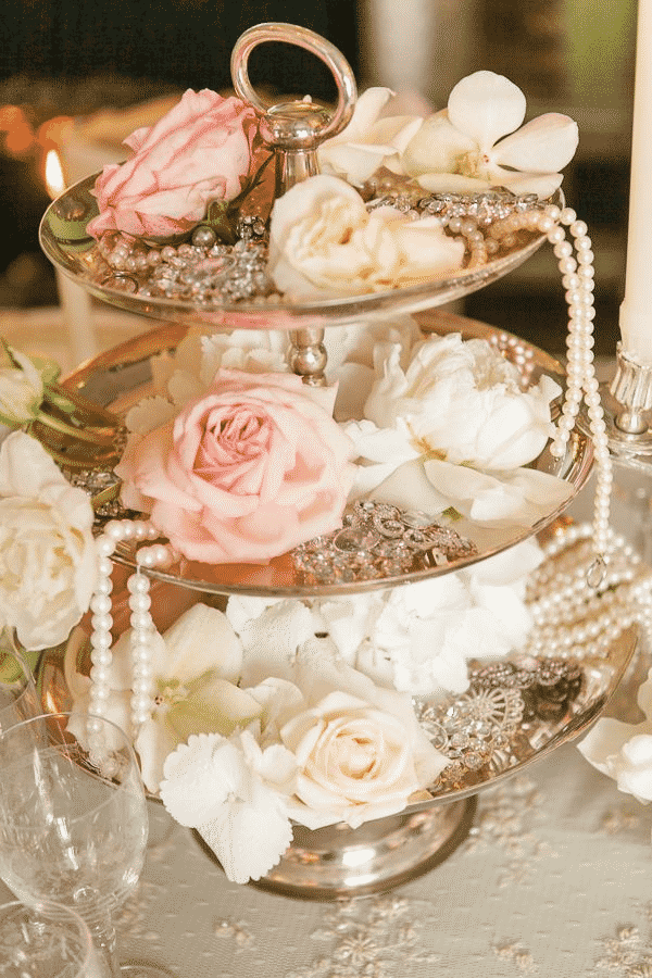 Three-tiered serving tray with roses.