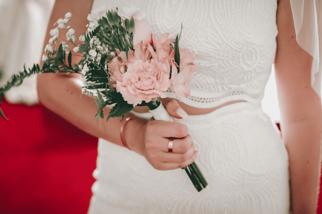 Bride in white dress holding flowers