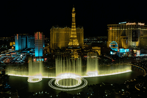 A nighttime view of Las Vegas’s Eiffel Tower and massive fountain show.