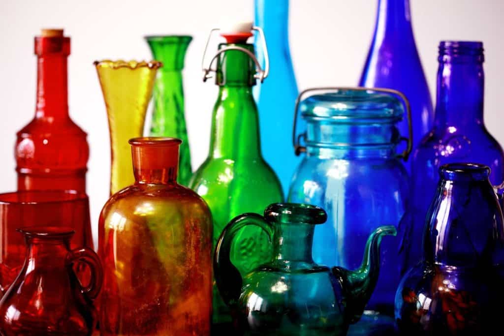 An assortment of rainbow colored glassware